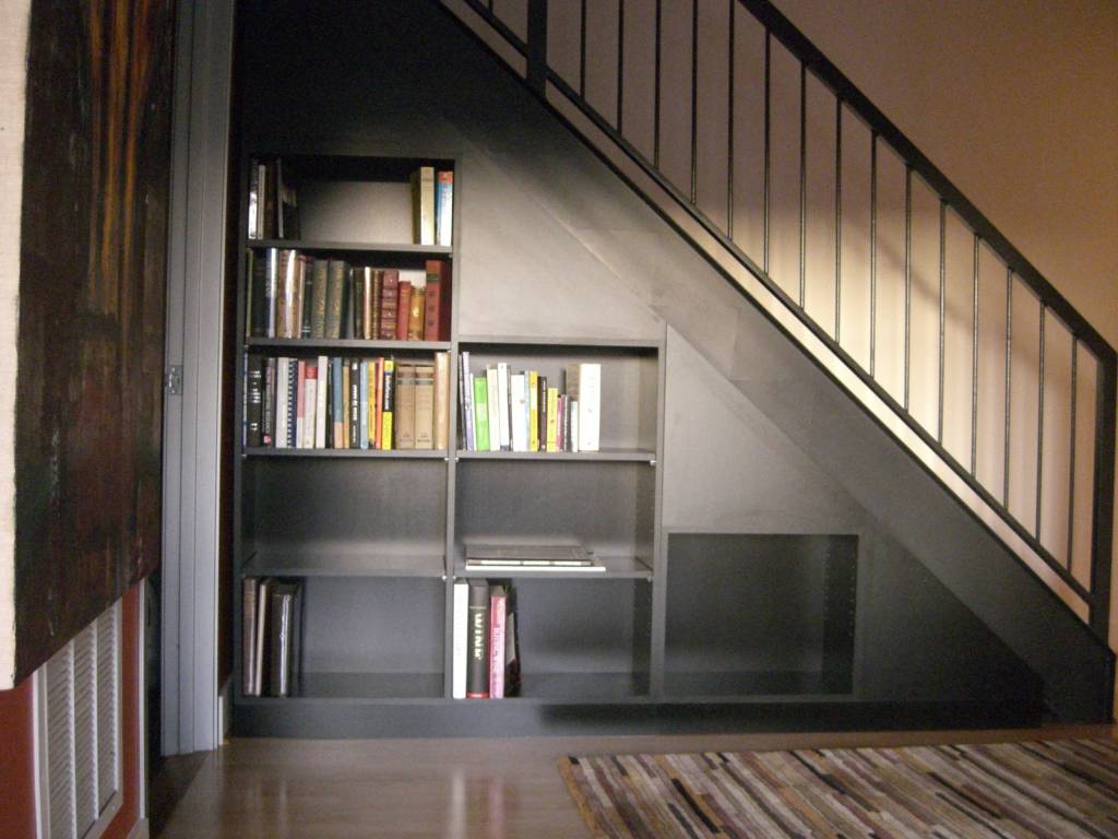 Bookshelves in the staircase as a great idea of space-saving techniques