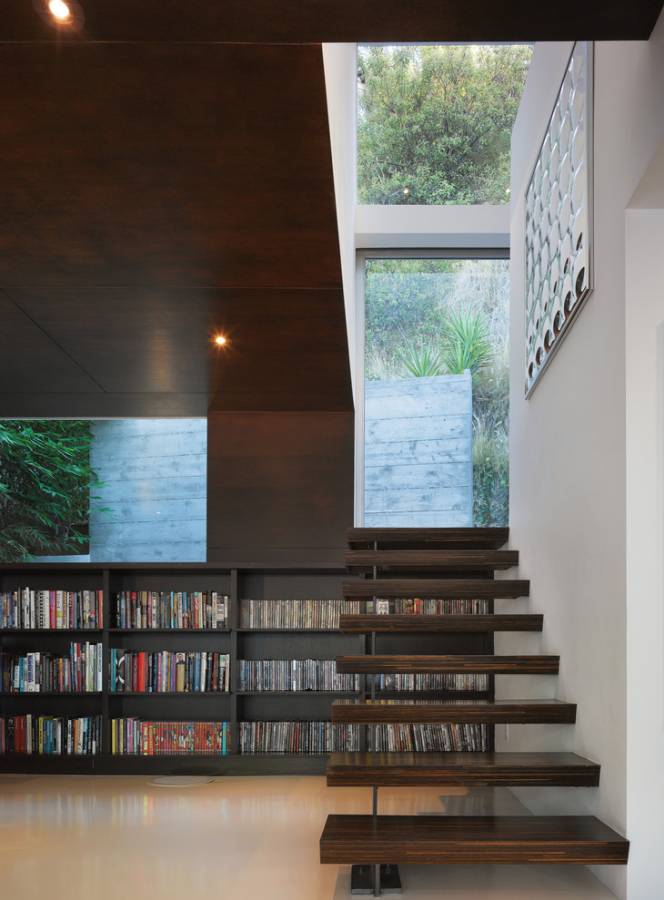 Bookshelves in the staircase as a great idea of space-saving techniques