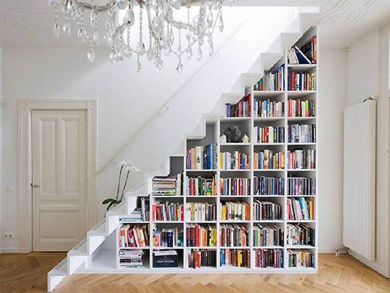 Bookshelves in the staircase as a great idea of space-saving techniques