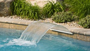 Outdoor swimming pool designs with waterfalls