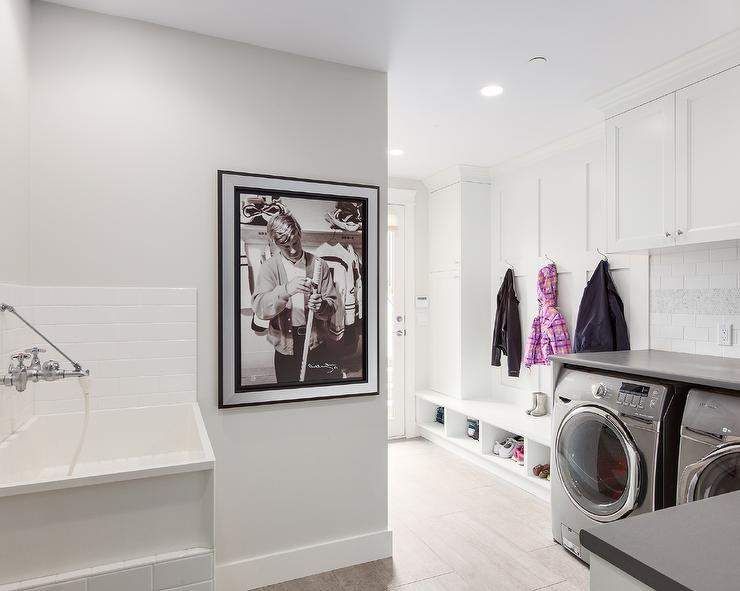 all white laundry room combined with a mudroom